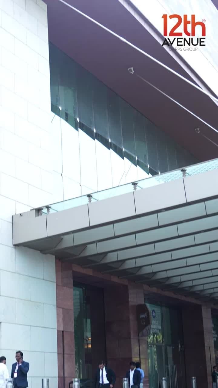Entrance plaza of 12th Avenue with glass canopy — official project image