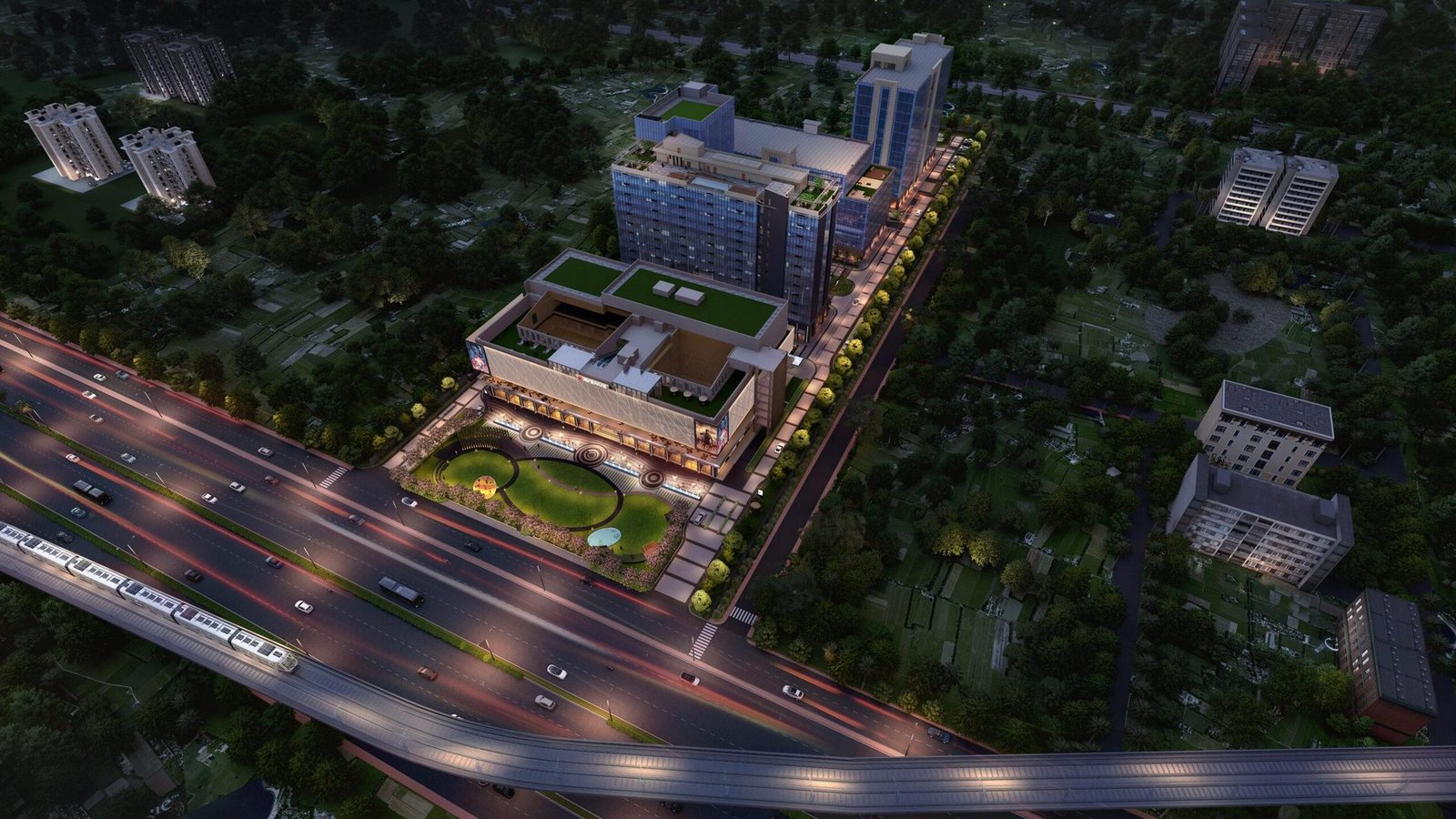 Aerial evening view of 12th Avenue by RPS Group on Delhi–Mathura Road, Faridabad, with the metro corridor and illuminated towers