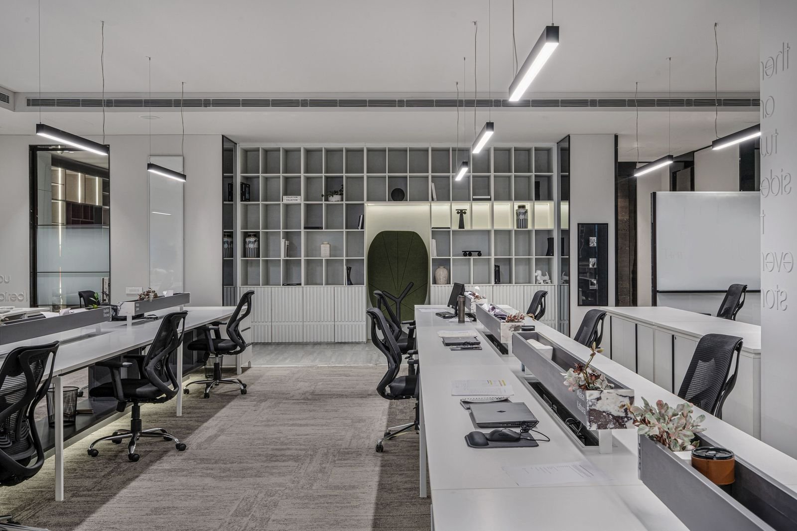 Open-plan modern office workspace with long desks